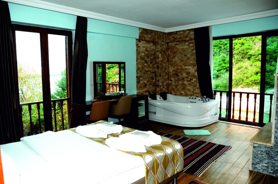 Deluxe Double Room, Jetted Tub, River View | Premium bedding, minibar, in-room safe, laptop workspace