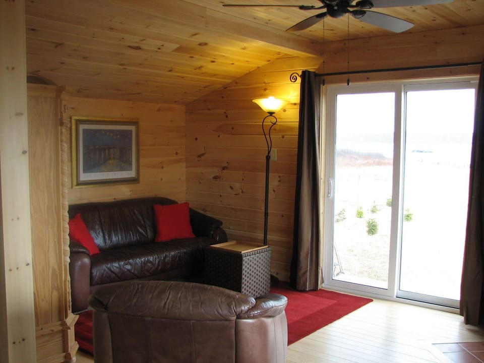Romantic Chalet, 1 Bedroom, Ocean View, Oceanfront | Living room | TV, fireplace, DVD player