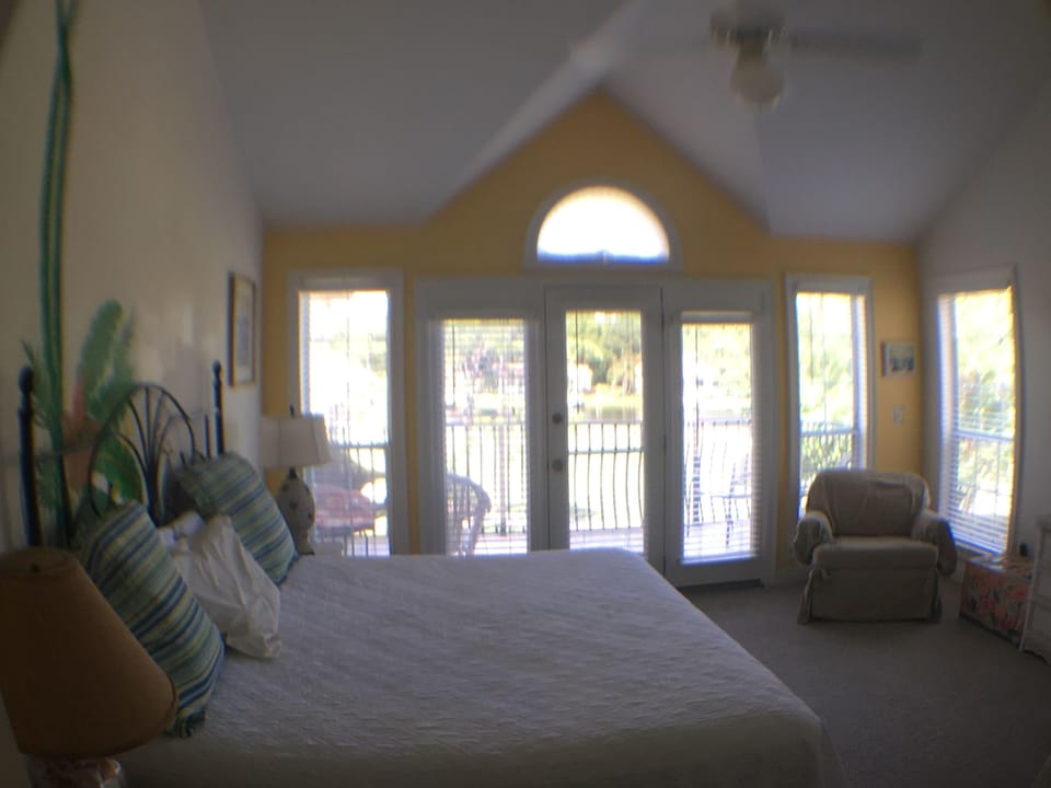 Upstairs Master with King bed with deck overlooking golf course, lake and bay