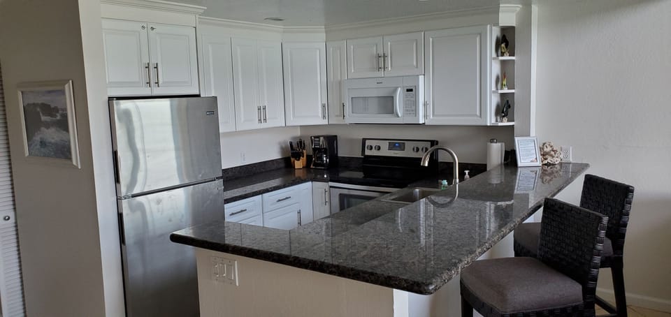 Updated kitchen with new cabinet doors, granite, stainless steel appliances