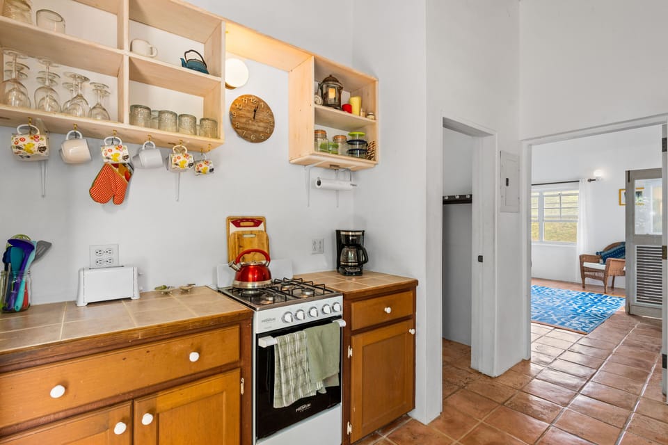 Makere Cottage kitchen showing doors to bathroom and master bedroom.
