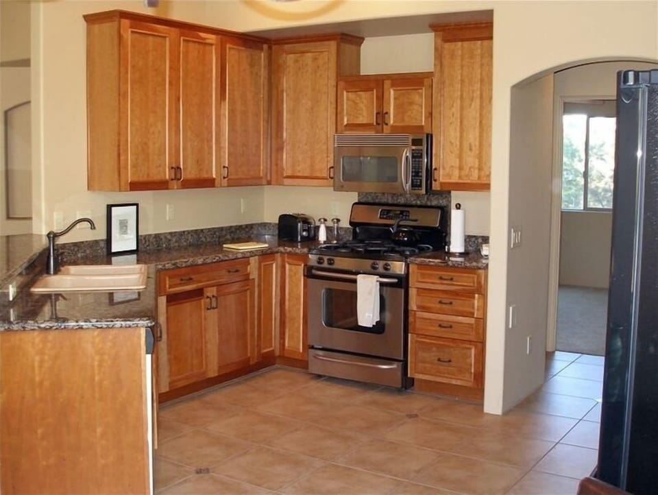 Spacious kitchen stocked with essentials.