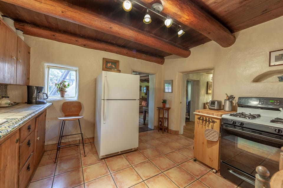 A sweet, traditional kitchen with everything you need to prepare and serve meals