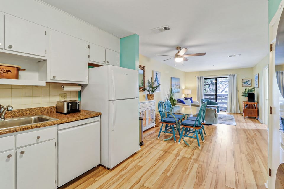 View of condo from entry. Kitchen to DR to LR with bedrooms (now shown) to right