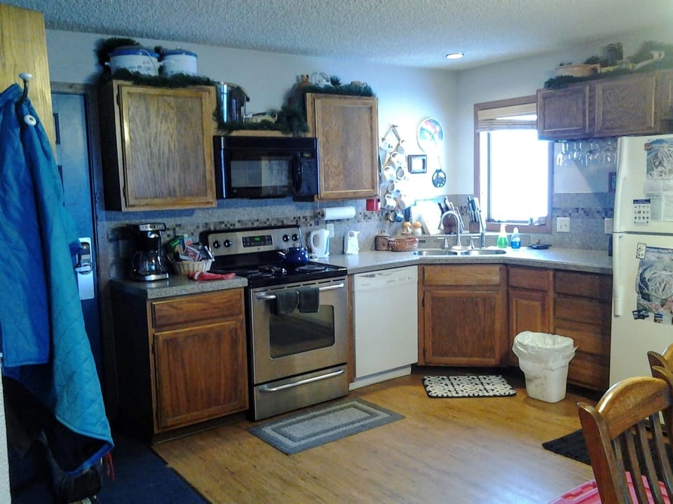 Kitchen view from dining room. crock pots, coffee maker, blender, toaster