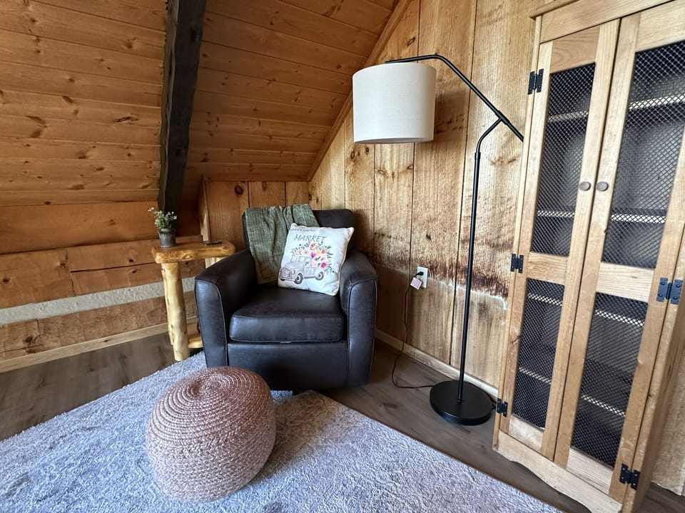 Cozy loft sitting area with a writing desk and an amazing view.