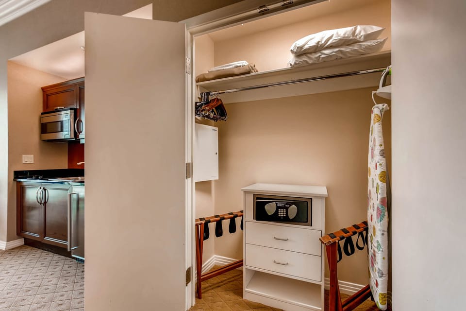 Closet with iron, guest safe, bath robes, etc.