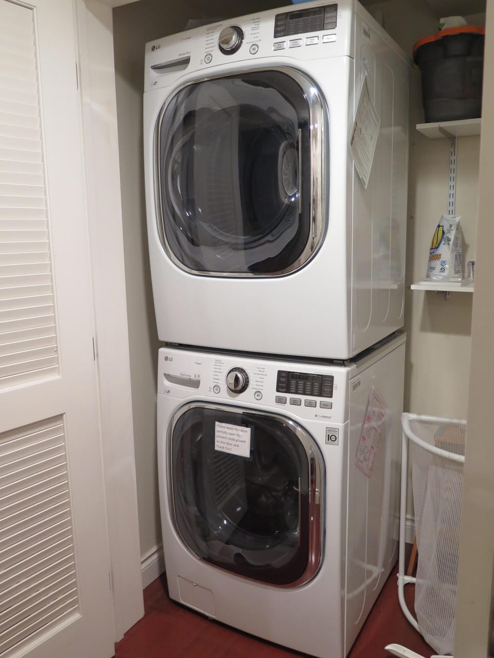 Full size LG washer dryer in laundry closet
