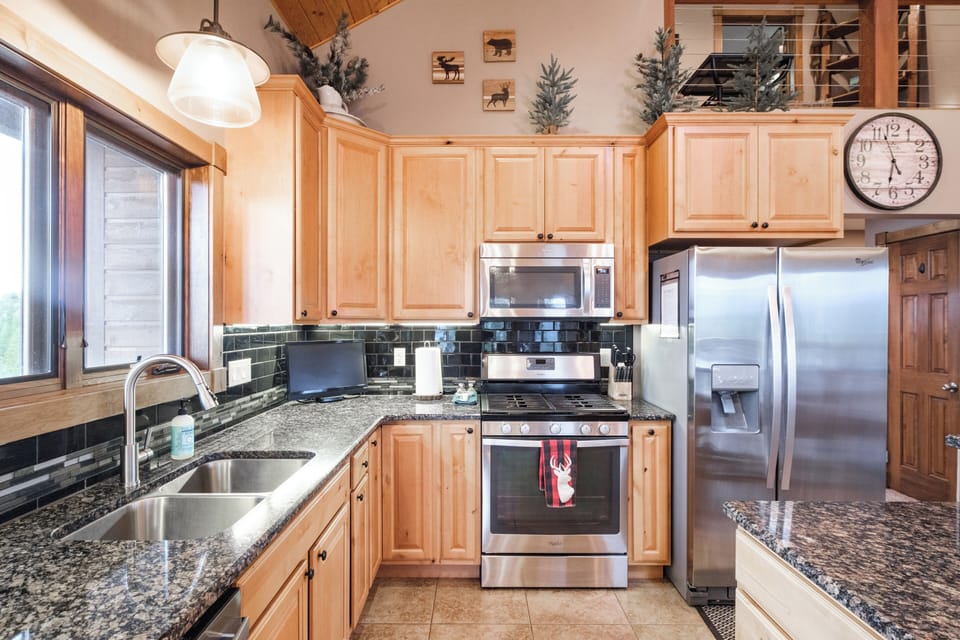 Open gourmet kitchen with essential appliances and some pantry essentials