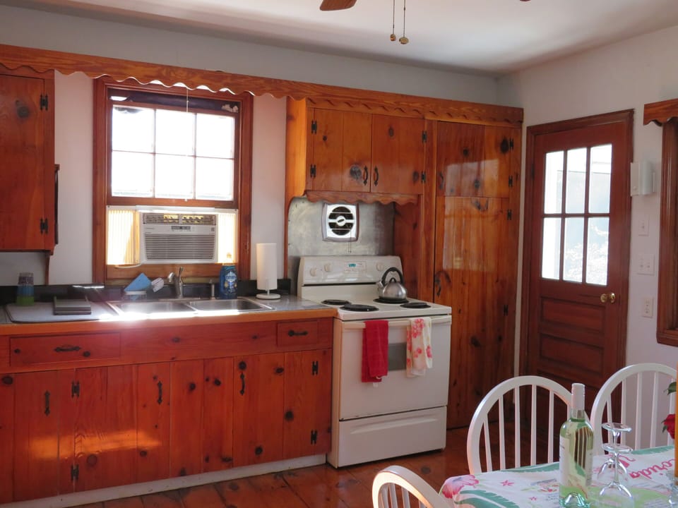 Kitchen featuring antique knotty pine cabinets