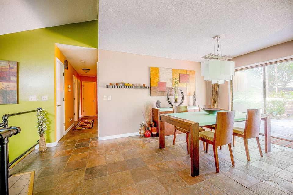 The hallway leading to the three bedrooms and the dining room table with the view to the backyard...