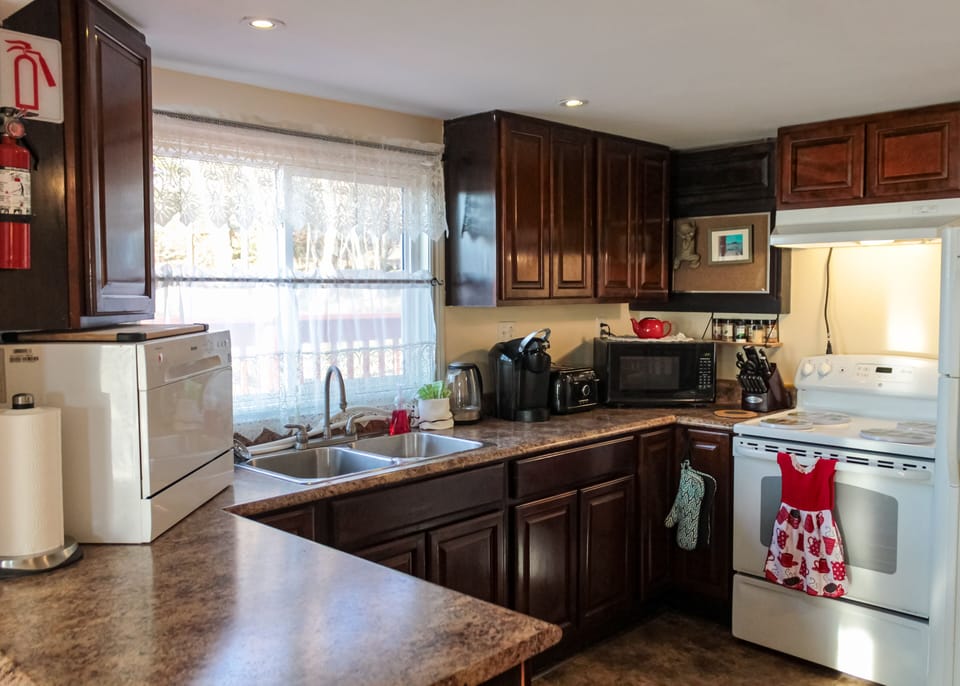 Kitchen has a full size fridge and stove as well as usual small appliances