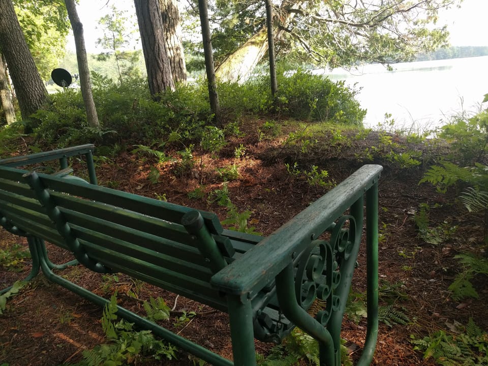 Relax in the glider by the shore of Guthrie Lake