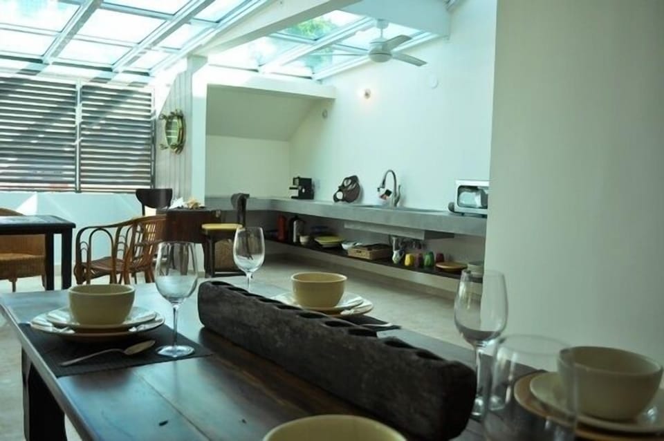Living room with kitchen. Have you seen the eye glass on the wall?