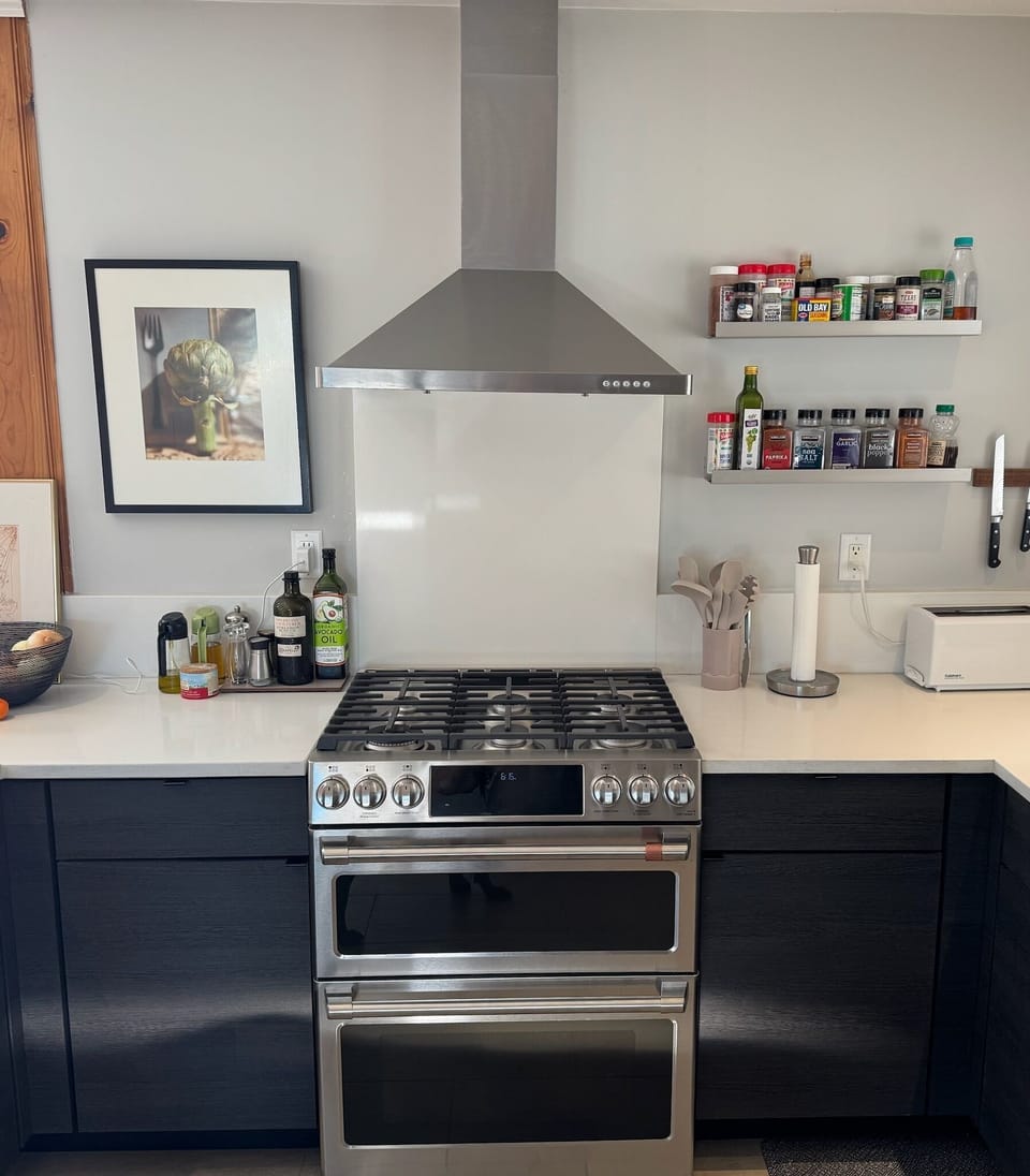 Kitchen with gas double-oven range and dishwasher.