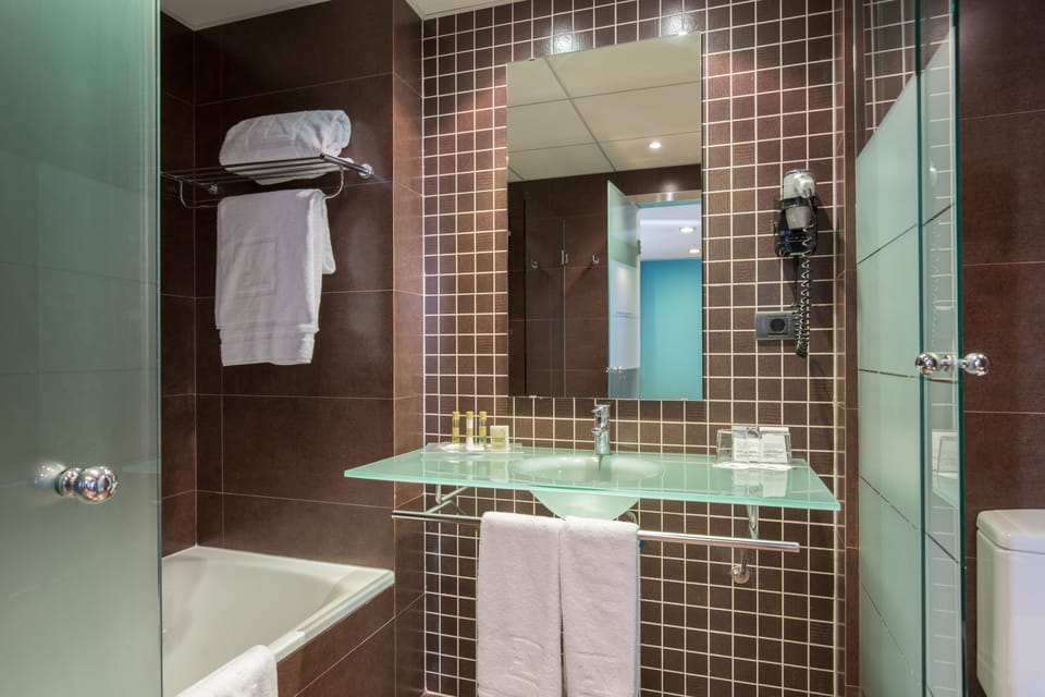 Eco-friendly toiletries, hair dryer, bidet, towels