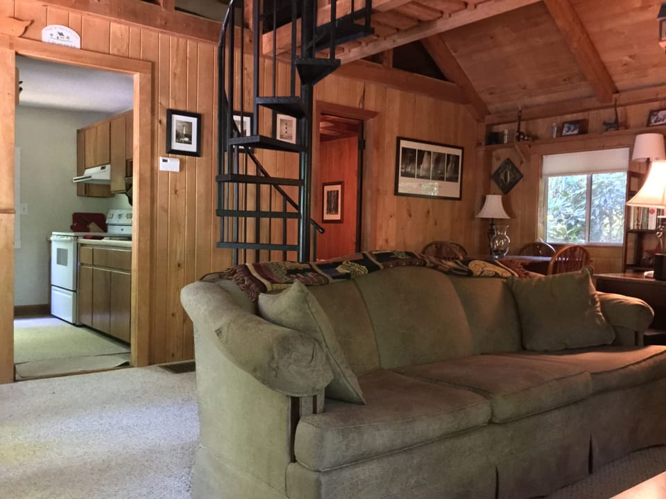 Living area & staircase to loft  with vaulted tongue and grove wood ceiling