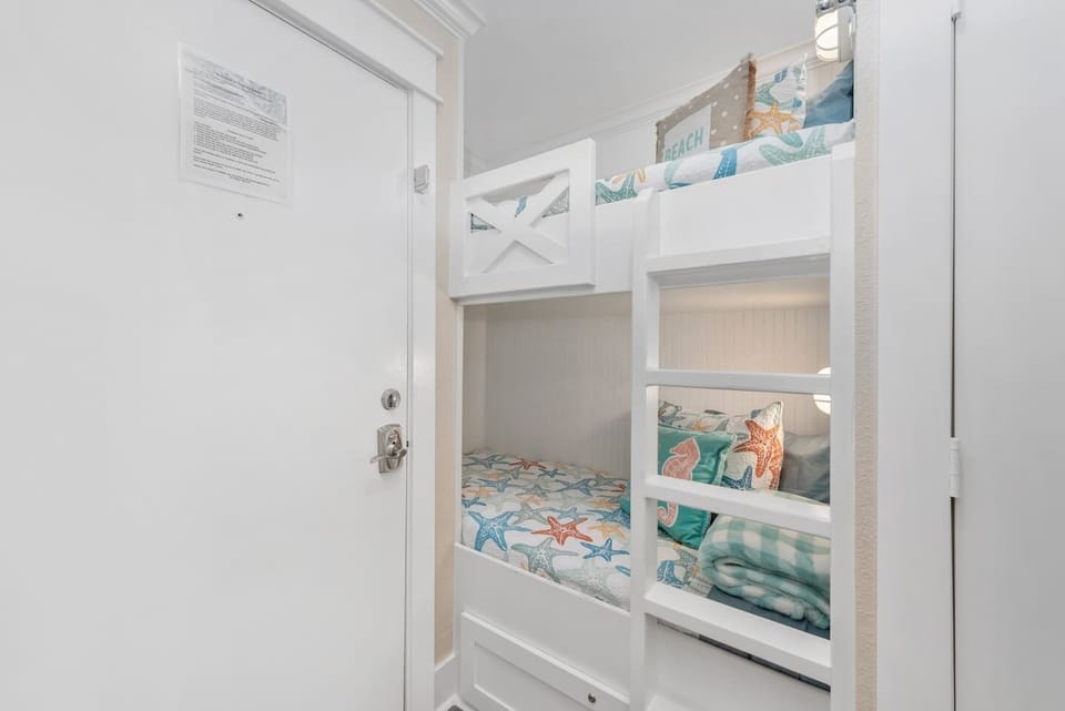 The twin bunk beds offer a cozy retreat for dreams filled with sandcastles and starfish.