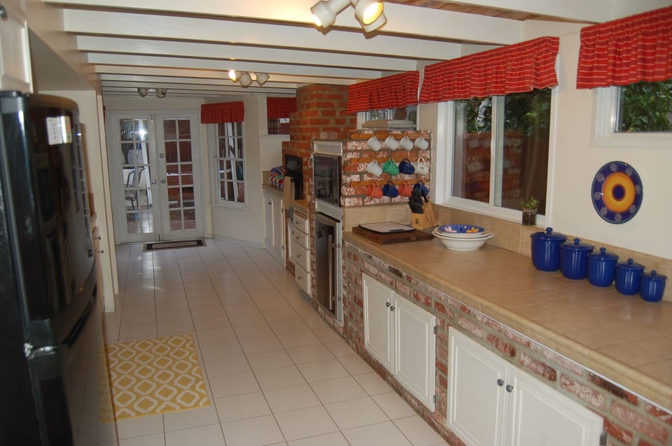 Kitchen- dishwasher, coffee maker, pots & pans, utensils, plates, condiments