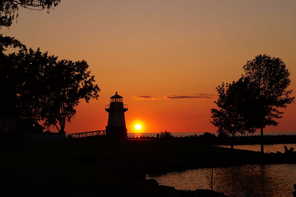 Sunset over Oak Orchard Pier and lighthouse
