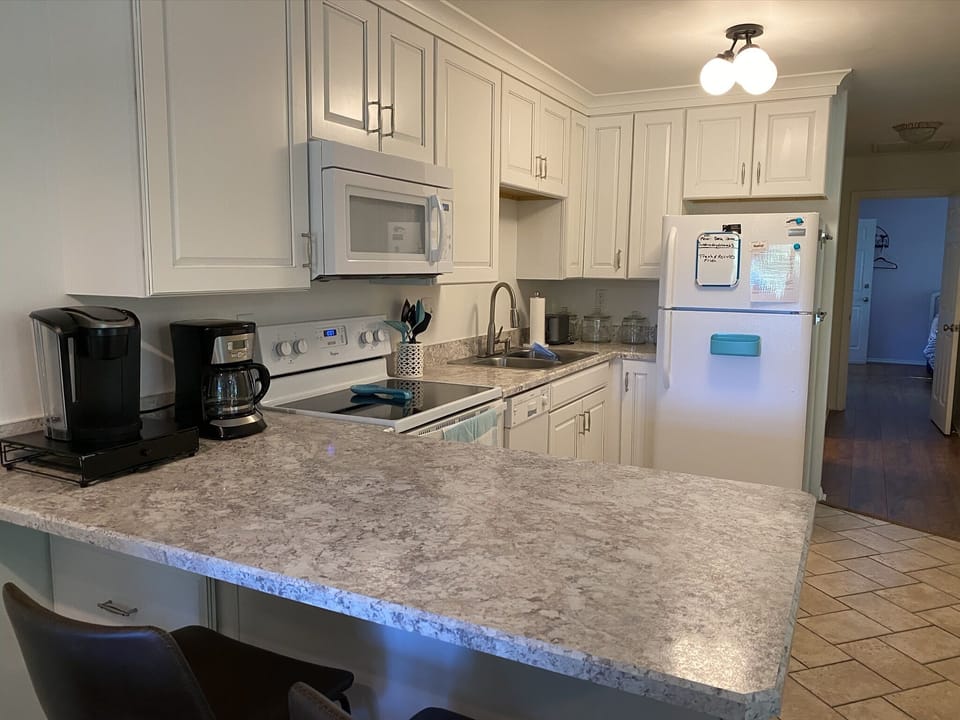 Kitchen with view of bedrooms and bathrooms down the hallway.
