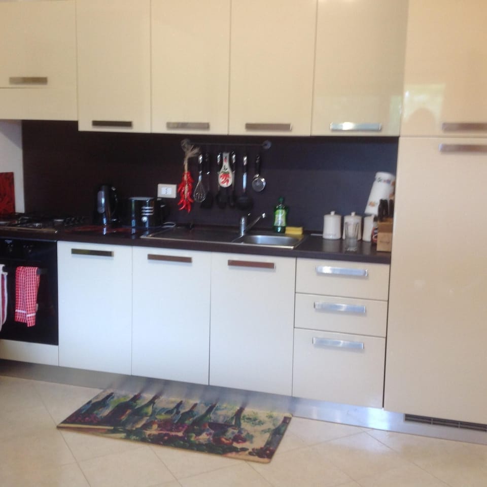 Modern fully equipped kitchen with built in cooker, oven & large fridge freezer