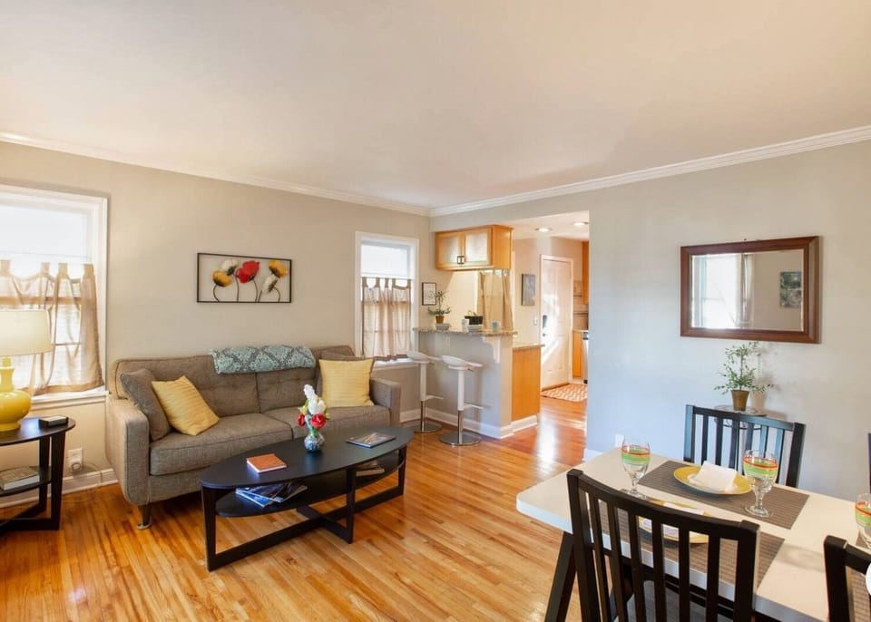 Inviting and comfortable living and dining area with wood floors.