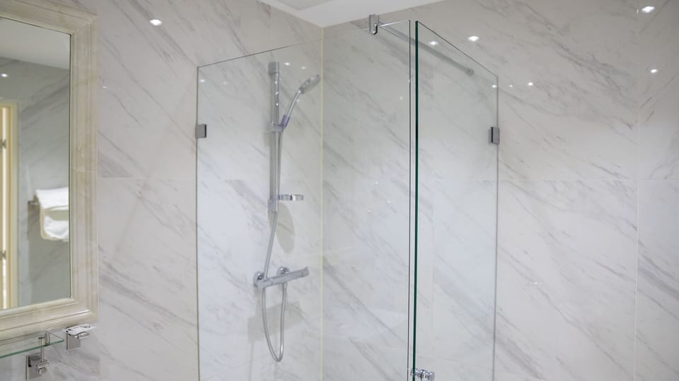 Shower, designer toiletries, hair dryer, towels