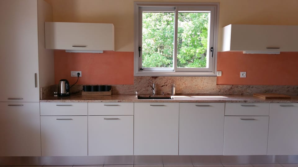 Well equipped kitchen looking onto village, access to veranda and dining area