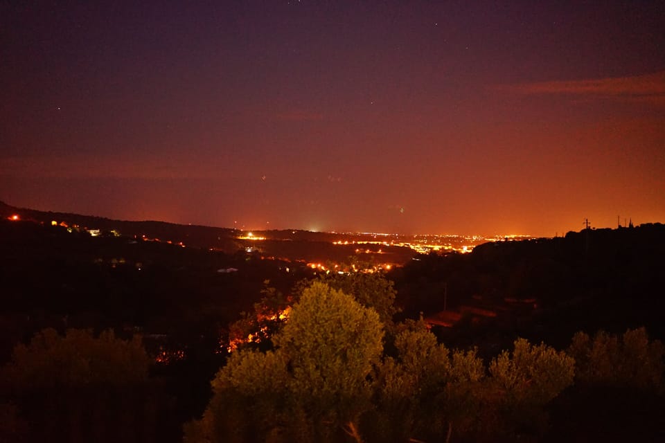 Pool Area View at Night Over City Lights