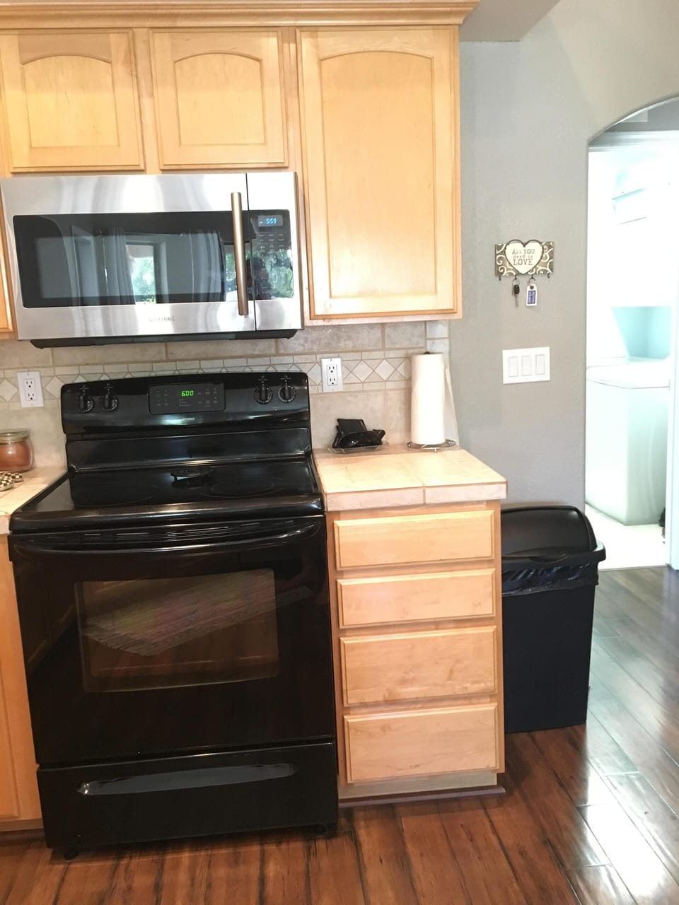 Electric stove, kitchen has microwave, refrigerator, dish washer