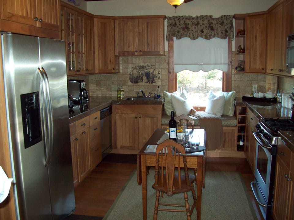 Beautiful window seat and plenty of cooking items to use.