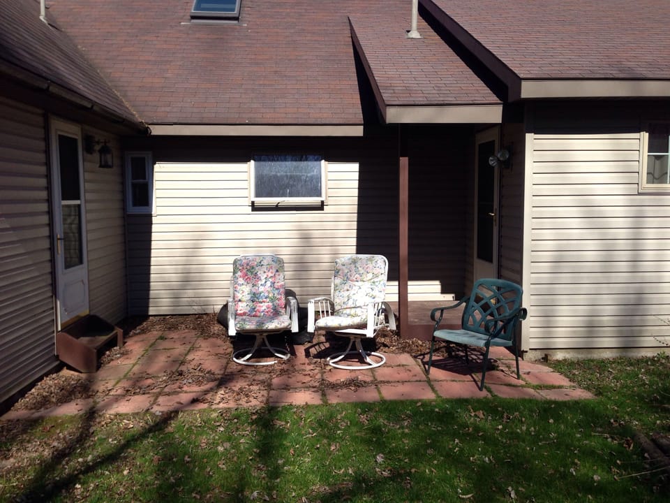 Sitting area in back surrounded by woods