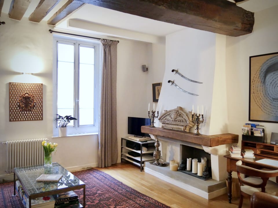 The fireplace is next to the television w Netflix, Apple TV , cable TV & blu-ray