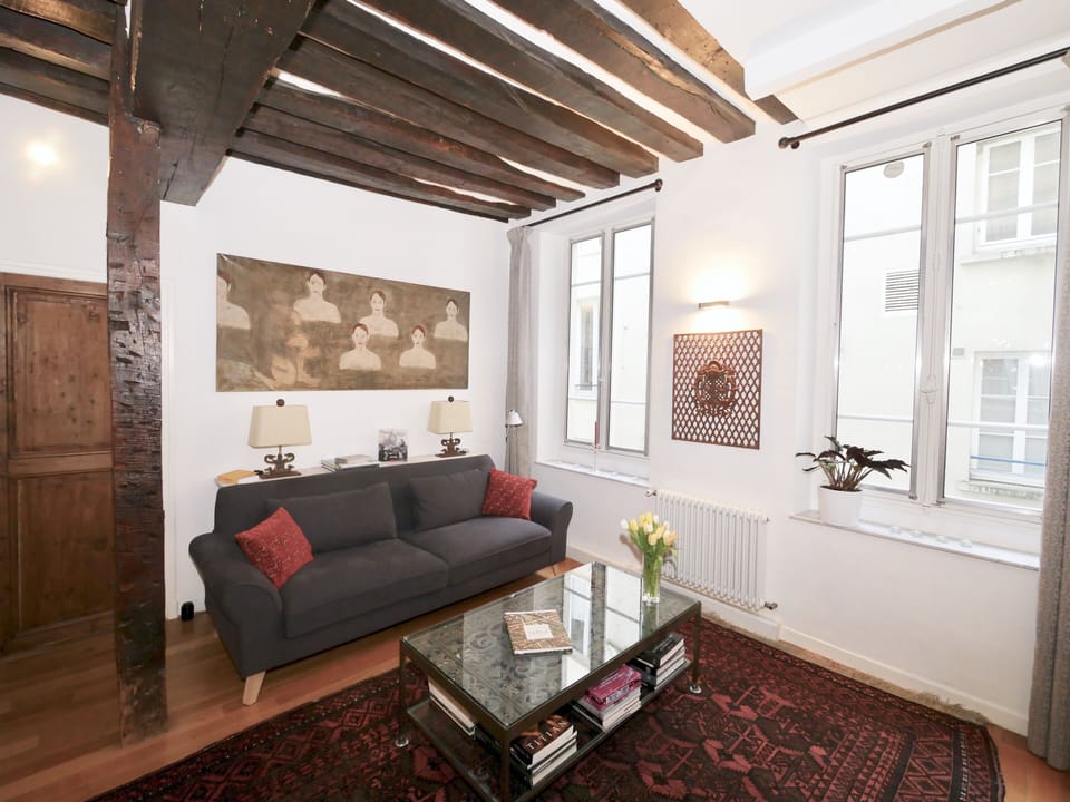 The sitting-room features designer sofa, Persian rugs and various antiques
