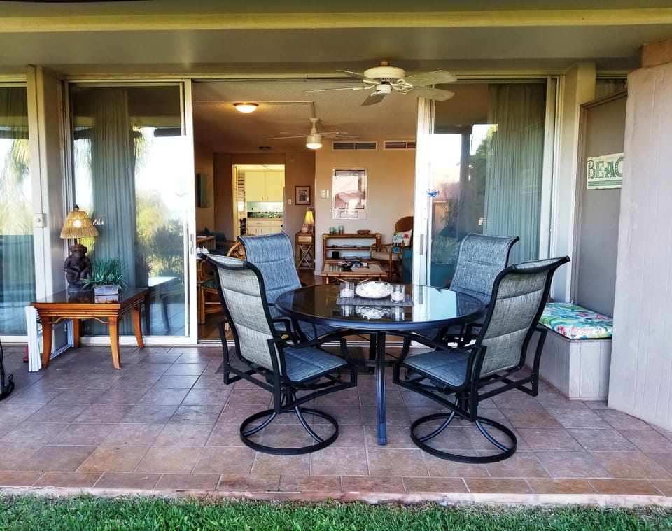 Large Patio Dining Area with Bench Full of Beach Toys and Snorkeling Equipment
