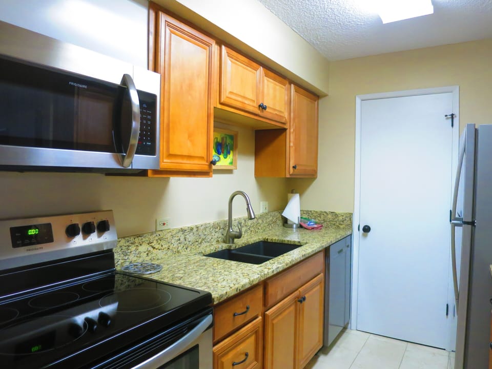 THE KITCHEN IS UPDATED WITH GRANITE  COUNTERS AND STAINLESS STEEL APPLIANCES