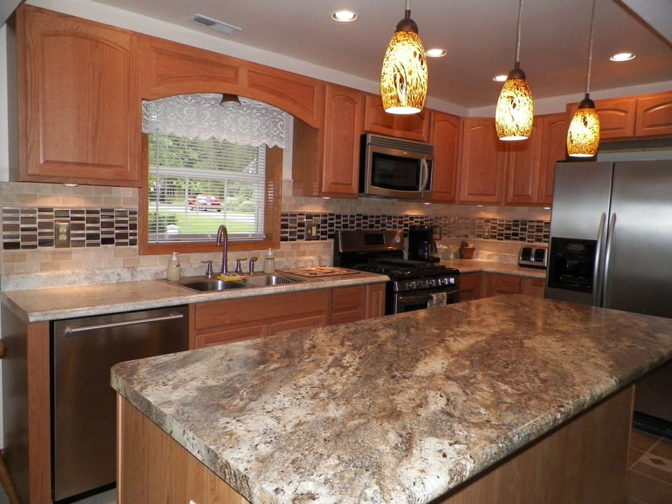 Open kitchen with island & custom tile design.