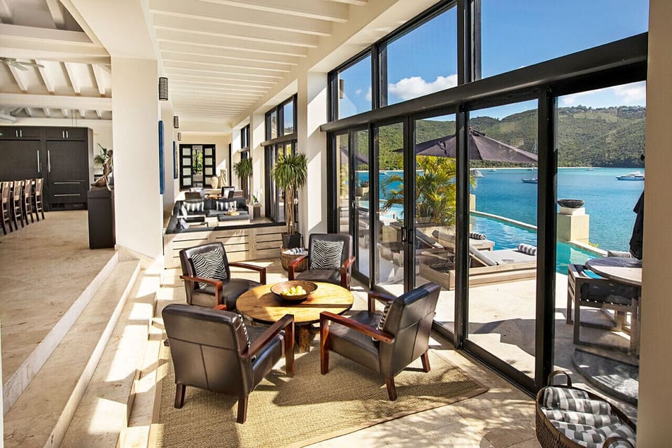 The sunken area of the living room, adjacent to the pool deck.