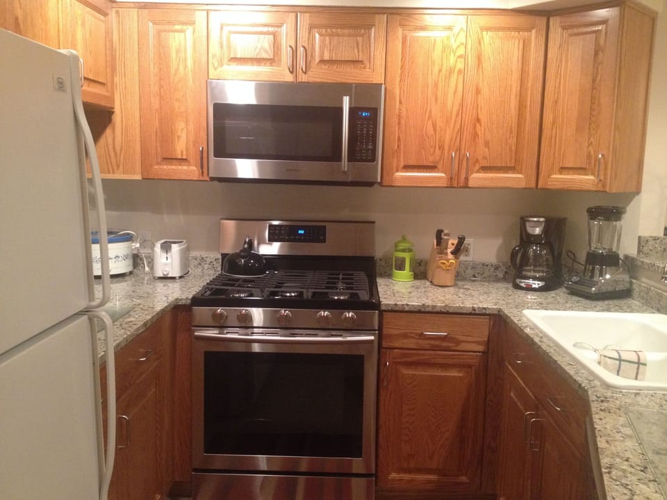 New gas range, microwave, kitchen countertops and cabinets from a 2015 remodel.