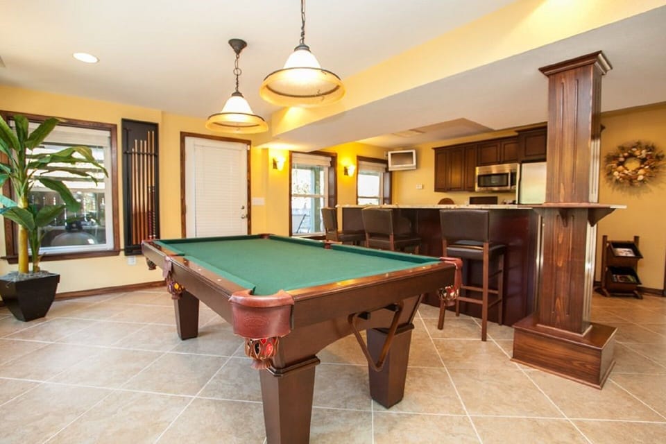 Ground floor sports lounge w/ wet bar, bar tv, fridge, microwave & billiards.