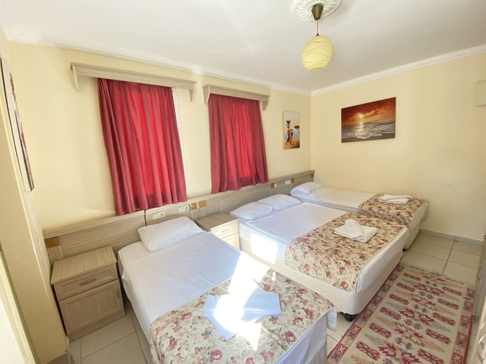 Deluxe Quadruple Room | Minibar, in-room safe, desk, iron/ironing board