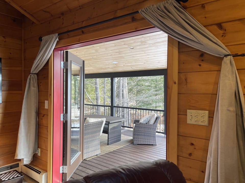 Walk out to enjoy the beautiful covered deck and beautiful vie of Lake Hermit. 