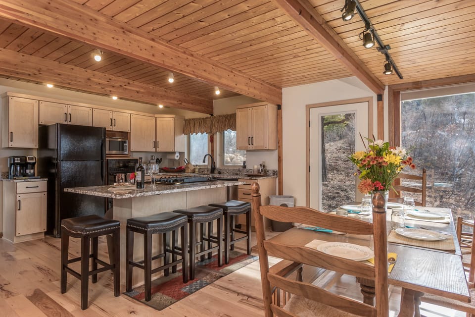 Family style kitchen with valley-views and access to back deck. 