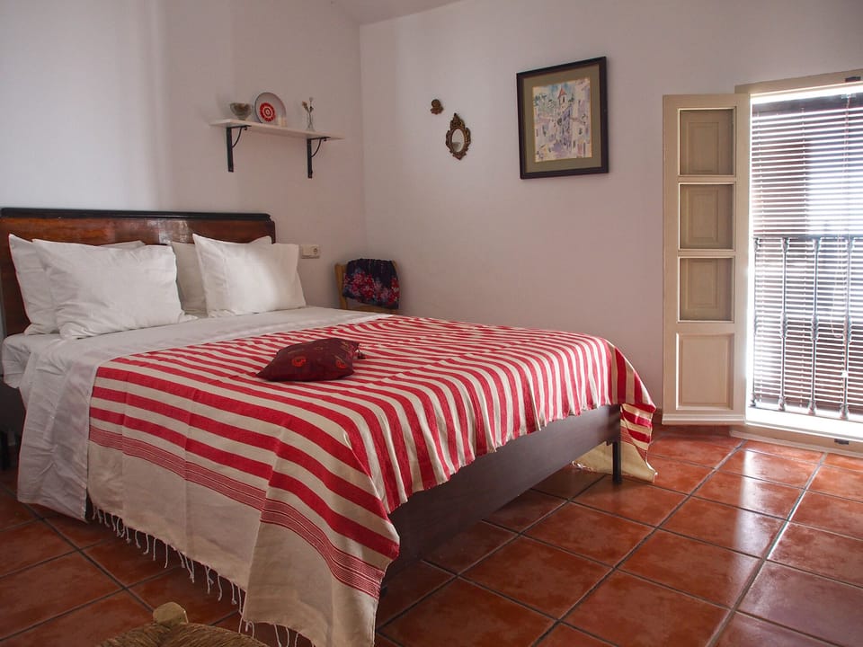 Master bedroom with balcony to the street