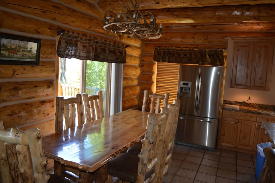 Custom 8 ft log dining table, chairs, benches & bar stools. 
