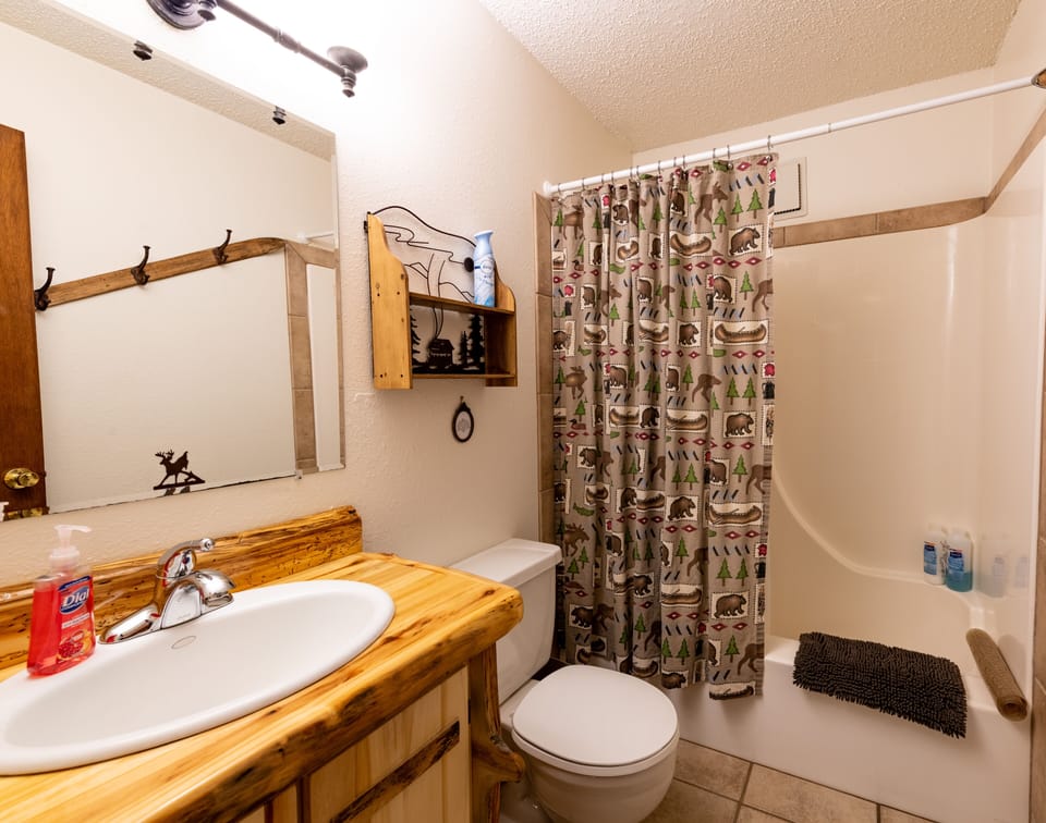 Full bathroom with tile floors, shower and bath.  Each condo has 1 bathroom.