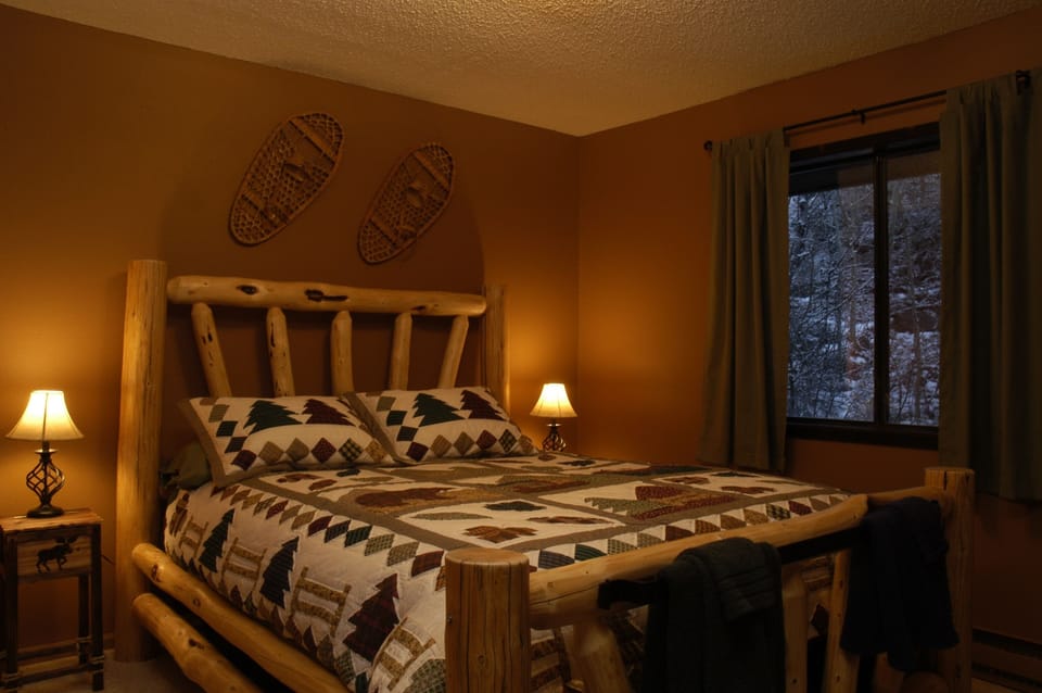 Cozy log queen bed.