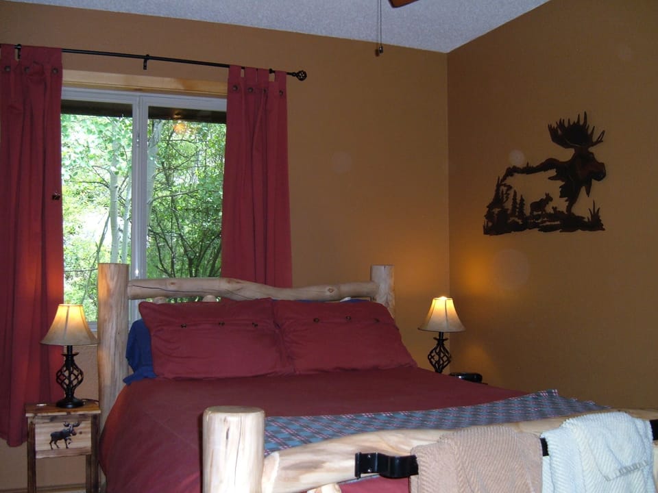 Snooze in a charming log bed at Ski Town Condos in Monarch. Double size bed.