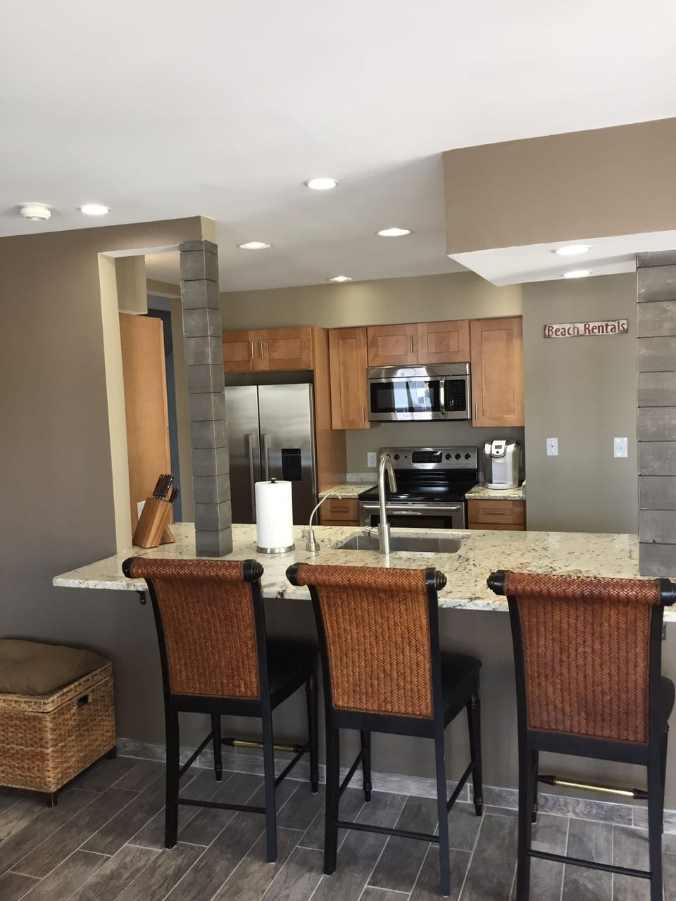 A breakfast bar viewing the kitchen with space for 5